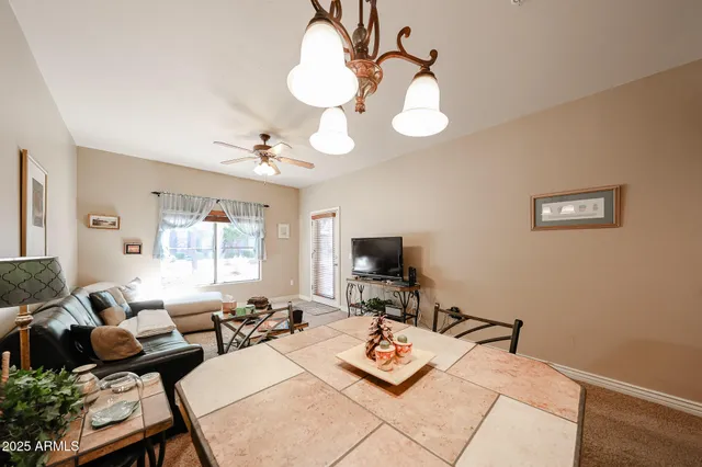 a living room with furniture a flat screen tv and a window