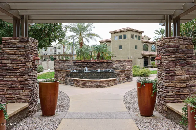 a view of a patio with plants and chairs