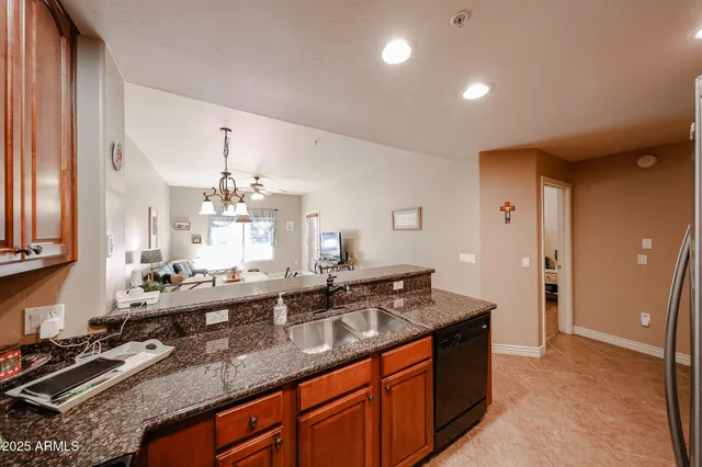 a large kitchen with kitchen island a sink stainless steel appliances and cabinets