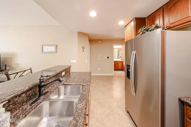 a kitchen with stainless steel appliances granite countertop a refrigerator and a sink