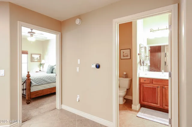 a bedroom with a bed and a mirror