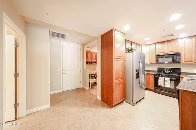 a view of kitchen with stainless steel appliances refrigerator stove microwave and oven