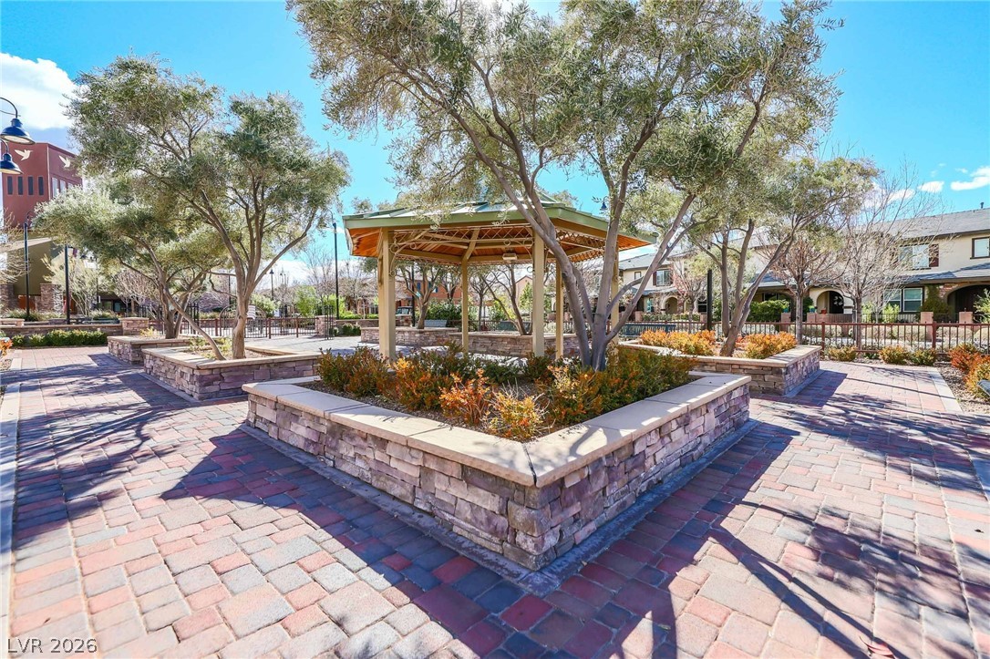 3175 Via Seranova Henderson, NV 89044 - Photo 44 of 45 This inviting community space features lush landscaping and a charming gazebo, perfect for relaxation.
