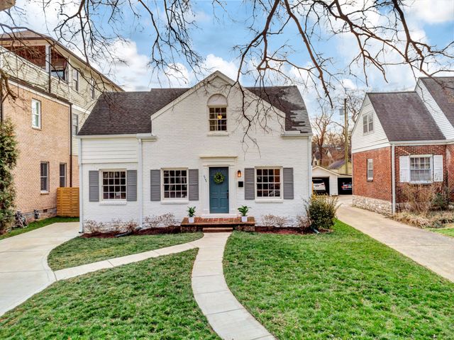 a view of a hallway to a livingroom with furniture