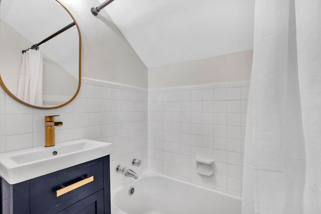 a bedroom with a bed furniture and a book shelf