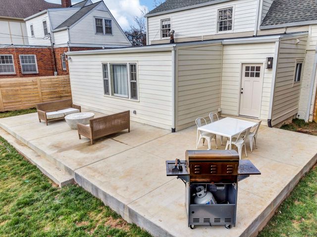 a view of a patio with couches table and chairs and potted plants