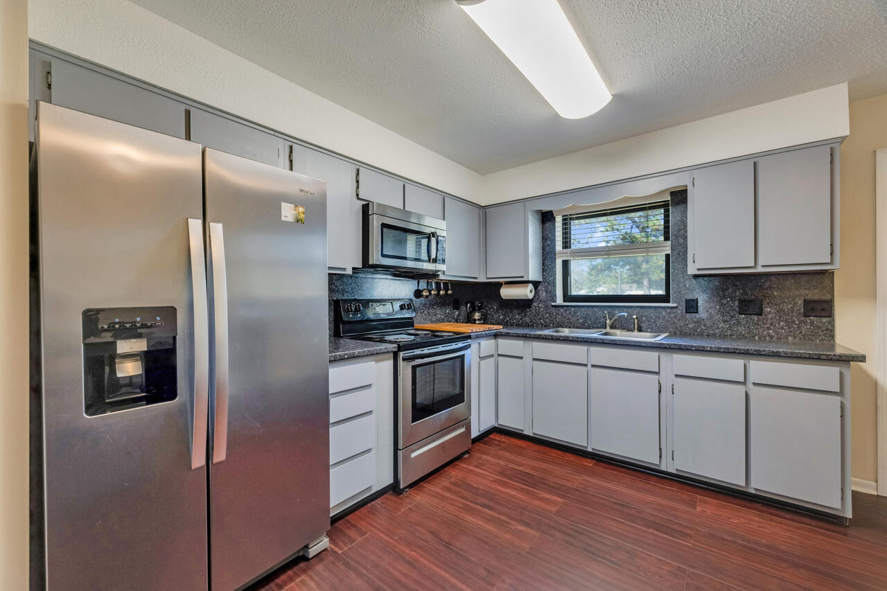 5448 Mt Olive Road Crestview, FL 32539 - Photo 11 of 37 a kitchen with stainless steel appliances granite countertop a refrigerator a stove and a sink