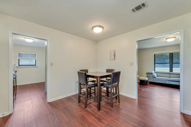 a view of a dining room with furniture and wooden floor