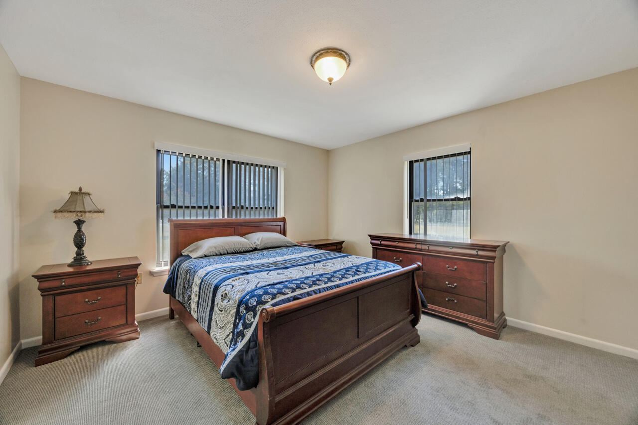 5448 Mt Olive Road Crestview, FL 32539 - Photo 16 of 37 a bed sitting in a bedroom next to a window