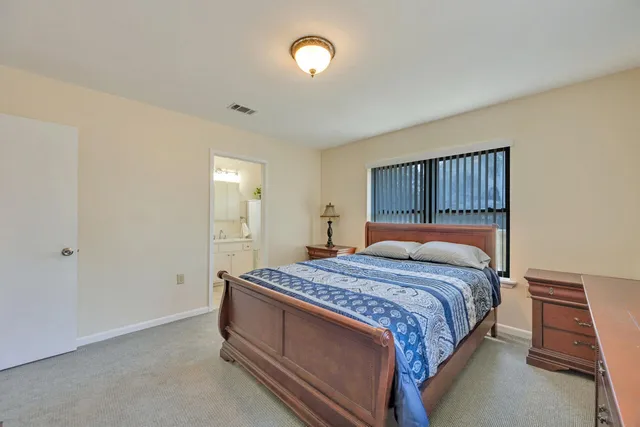 a bedroom with a bed and a night stand