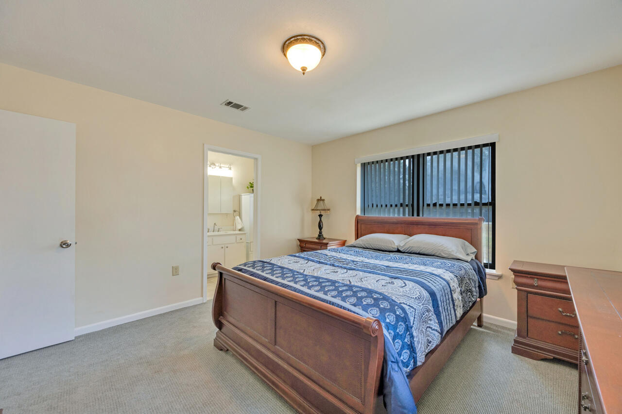 5448 Mt Olive Road Crestview, FL 32539 - Photo 17 of 37 a bedroom with a bed and a night stand