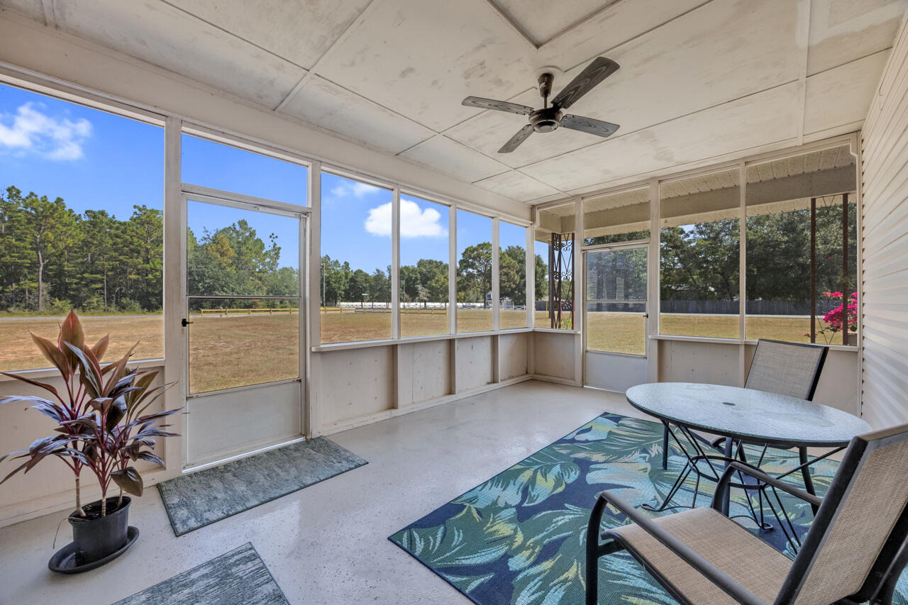 5448 Mt Olive Road Crestview, FL 32539 - Photo 24 of 37 a living room with furniture and a large window