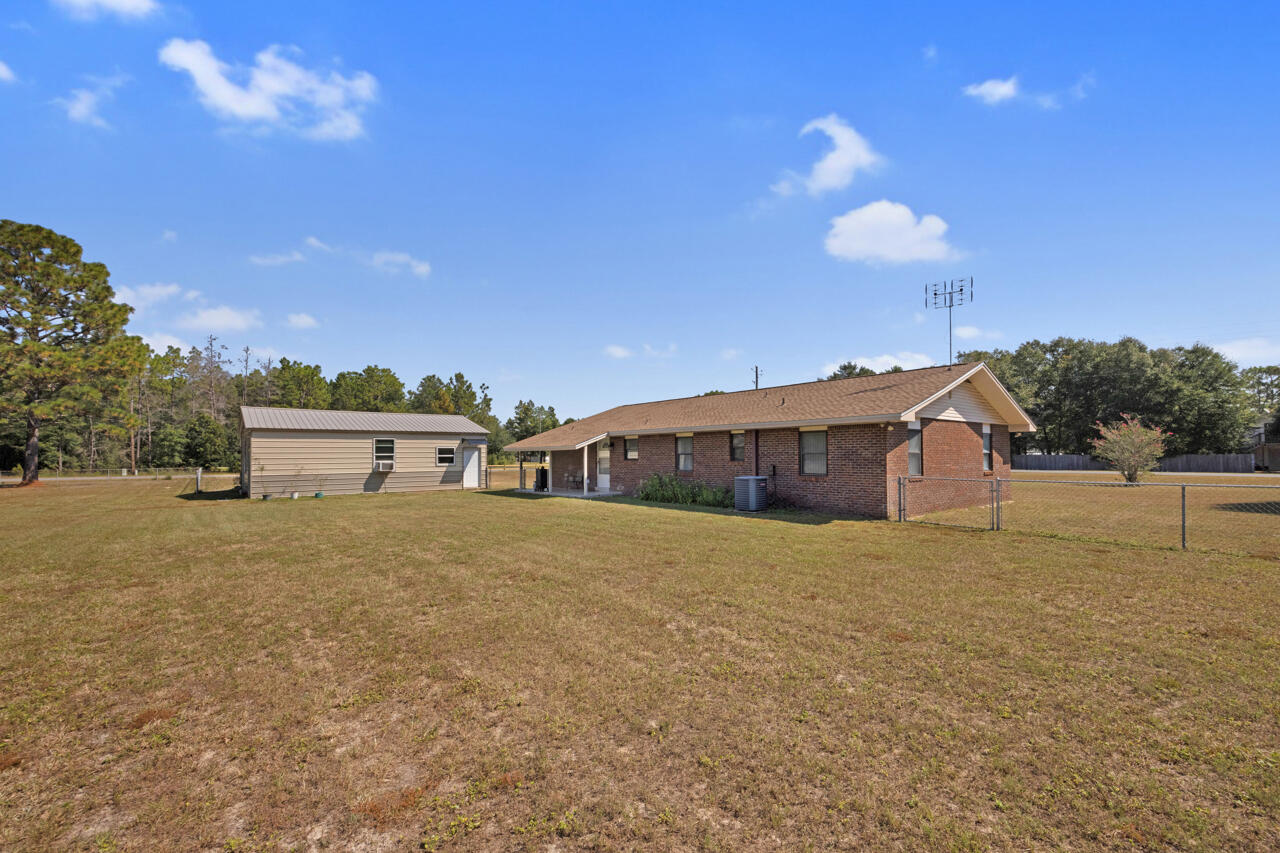 5448 Mt Olive Road Crestview, FL 32539 - Photo 27 of 37 a view of a house with a yard and large trees
