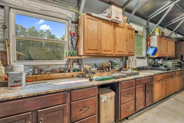 a kitchen with sink a window and cabinets