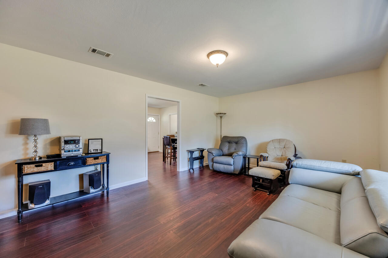 5448 Mt Olive Road Crestview, FL 32539 - Photo 6 of 37 a living room with furniture and a wooden floor