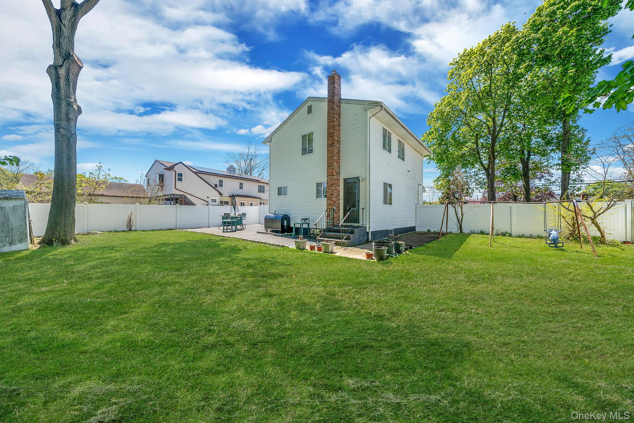 1169 Little E Neck Road West Babylon, NY 11704 - Photo 27 of 28 a view of a backyard with a garden and plants
