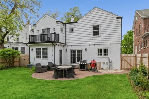 a view of a house with a yard and sitting area