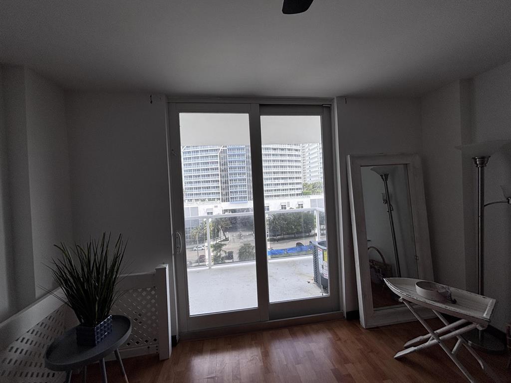 336 North Birch Road, Unit 8D Fort Lauderdale, FL 33304 - Photo 18 of 23 a view of a room with wooden floor and a window