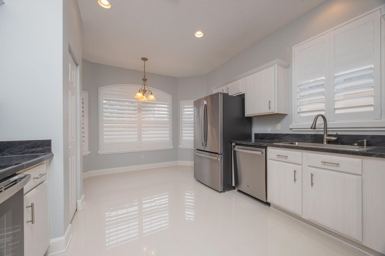 573 Boxwood Place St. Augustine, FL 32086 - Photo 16 of 40 a kitchen with refrigerator and window