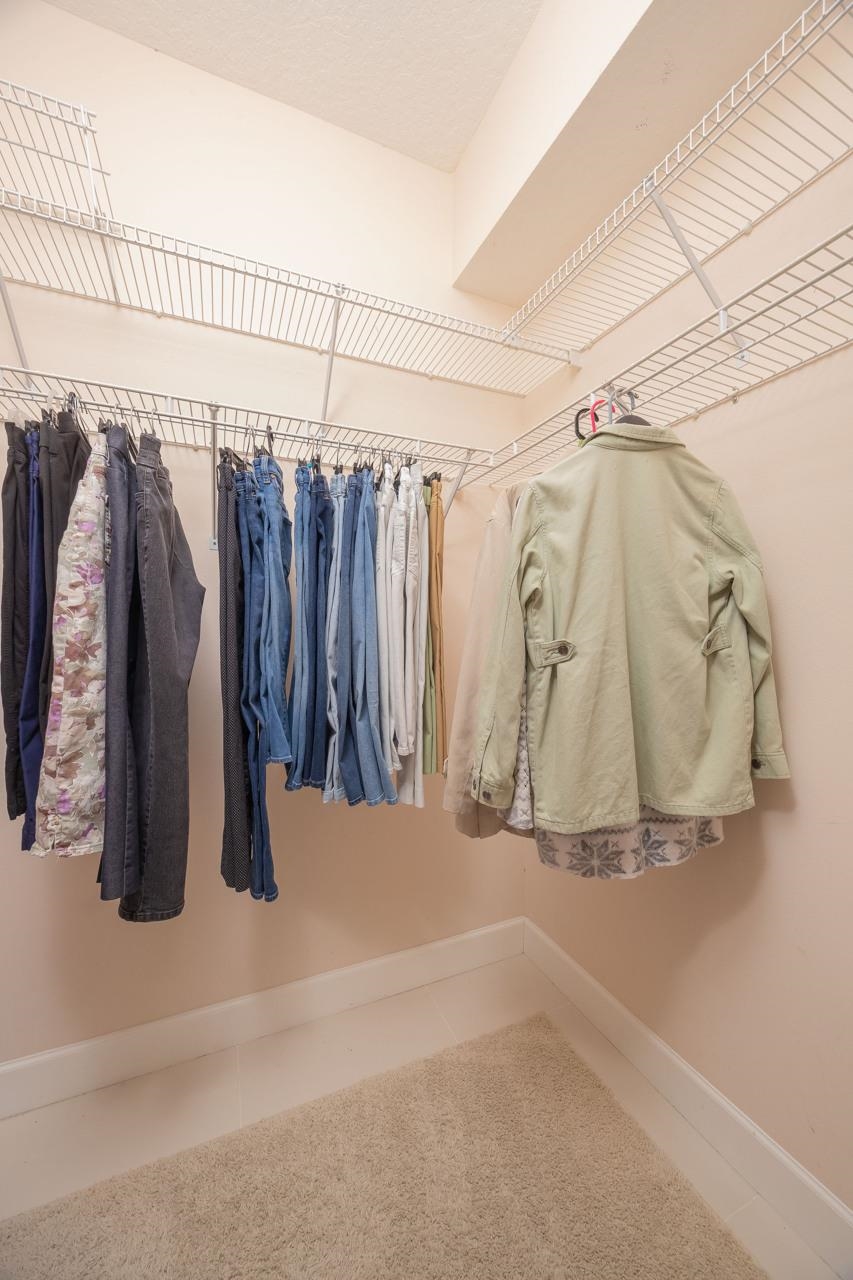 573 Boxwood Place St. Augustine, FL 32086 - Photo 32 of 40 a view of walk in closet with clothes and shoes