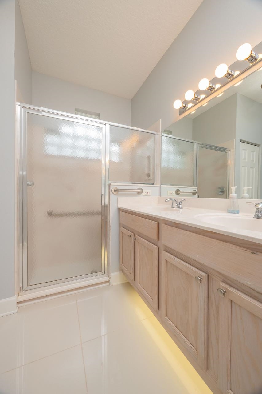 573 Boxwood Place St. Augustine, FL 32086 - Photo 35 of 40 a bathroom with a double vanity sink mirror and shower