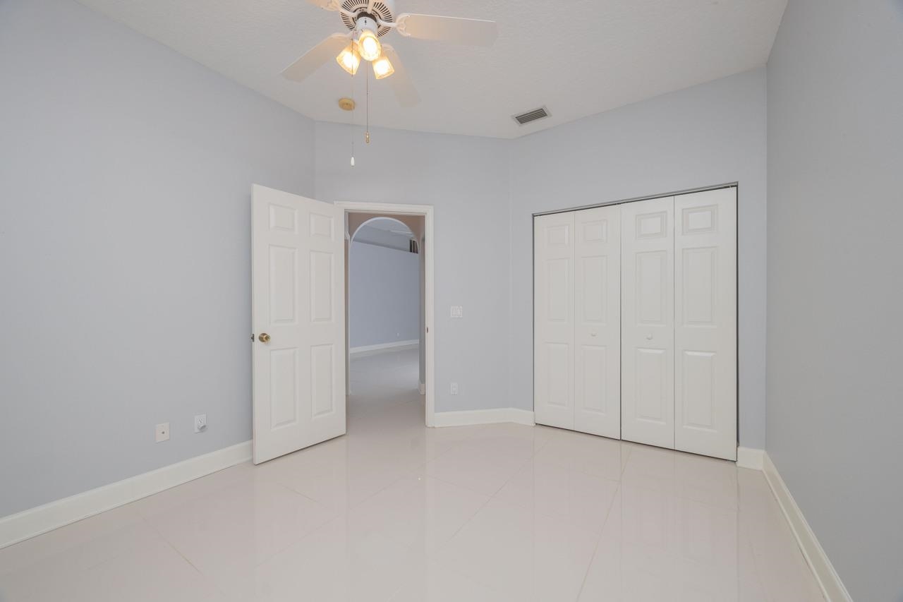 573 Boxwood Place St. Augustine, FL 32086 - Photo 37 of 40 an empty room with closet and a chandelier fan