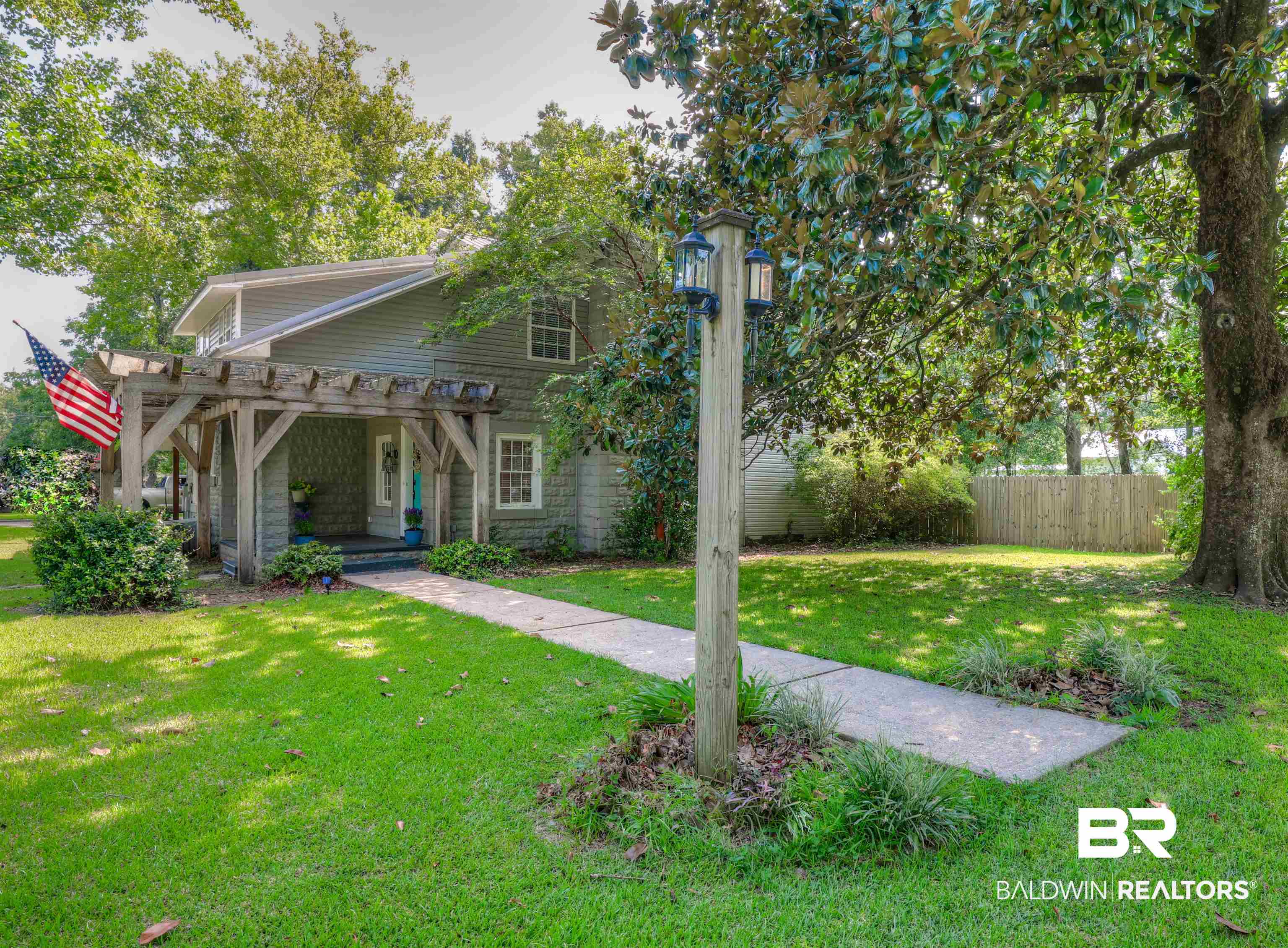 2079 Alabama Street Loxley, AL 36551 - Photo 2 of 42 View of front of home featuring a pergola and a front yard