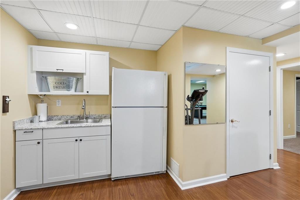 900 Settlers Ridge Road Pittsburgh, PA 15238 - Photo 36 of 50 The lower-level kitchenette, complete with a sink and refrigerator, enhances the space's functionality for guests, recreation, and entertaining.