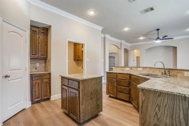 a spacious bathroom with a granite countertop sink a mirror and a shower