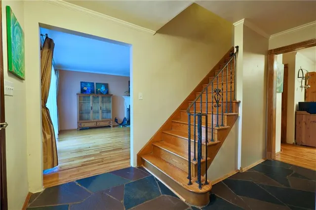 a view of entryway and hall with wooden floor