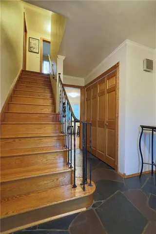 a view of entryway and hall with wooden floor