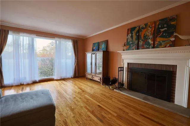 a view of a livingroom with a fireplace and window