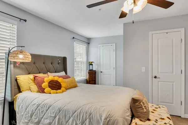a bedroom with a bed and a chandelier