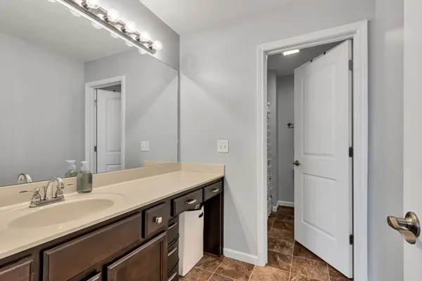 a bathroom with a double vanity sink and a mirror