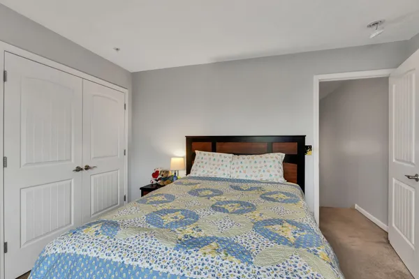 a bedroom with a bed and a dresser