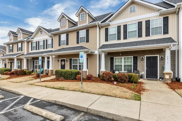 a front view of a brick house with outdoor seating