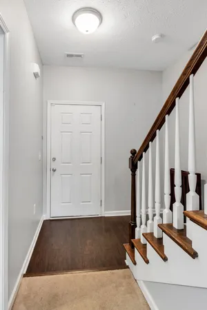 a view of front door with dining room and stairs