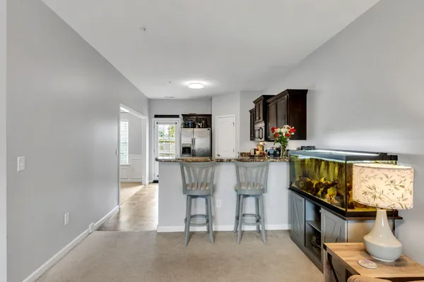 a kitchen with stainless steel appliances kitchen island granite countertop a stove and a sink