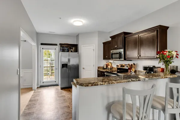 a kitchen with refrigerator and cabinets