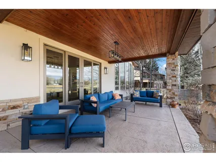 a living room with furniture a table and a large window