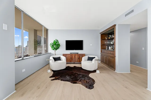 a kitchen with a sink a microwave and cabinets
