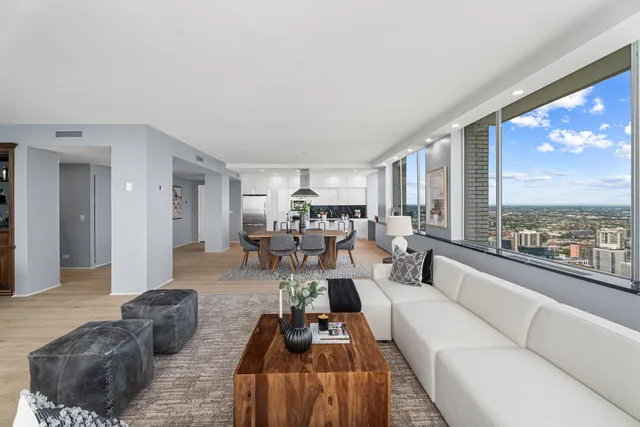 a bedroom with a bed and a potted plant on the dresser
