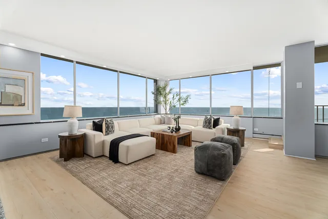 a living room with furniture and large windows