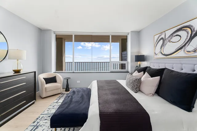 a bedroom with a bed and a potted plant