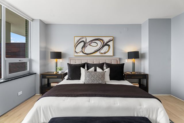 a bathroom with a granite countertop sink mirror vanity and toilet