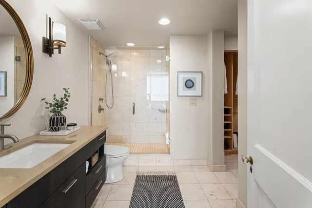 a bathroom with a sink a toilet and a mirror