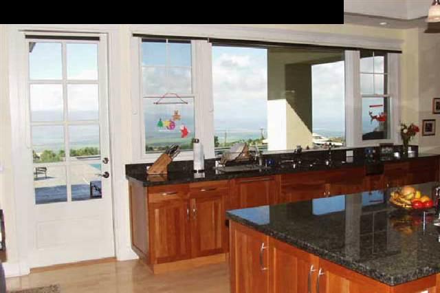 155 Pulehu Road Kula, HI 96790 - Photo 8 of 18 a kitchen with granite countertop a sink and a wooden cabinets