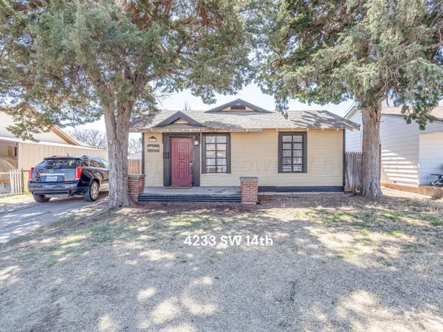 a view of a house with a large tree in front of a house
