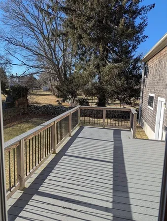 a view of balcony with wooden floor and seating space