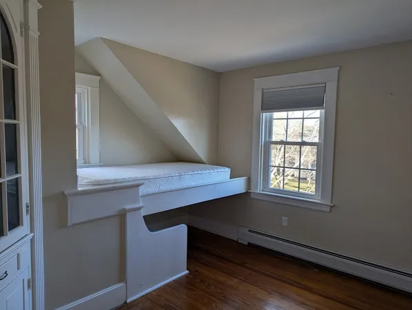 a view of room with window and wooden floor